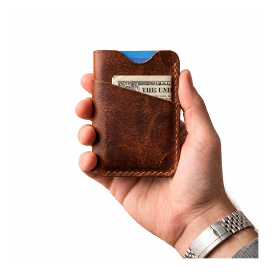 Full grain leather slim wallet for men in vintage cognac color held in hand minimal card holder